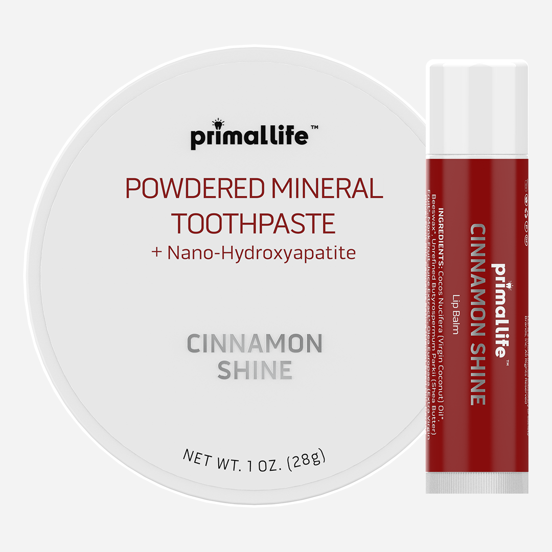Primallife powdered mineral toothpaste and cinnamon shine lip balm on a white background
